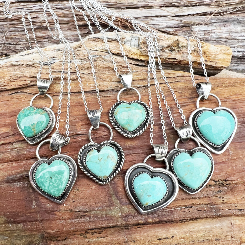Nestled atop a weathered wooden log, rests a collection of Native American jewelry. Each piece, meticulously crafted from silver and turquoise, tells a story of tradition and craftsmanship passed down through generations.